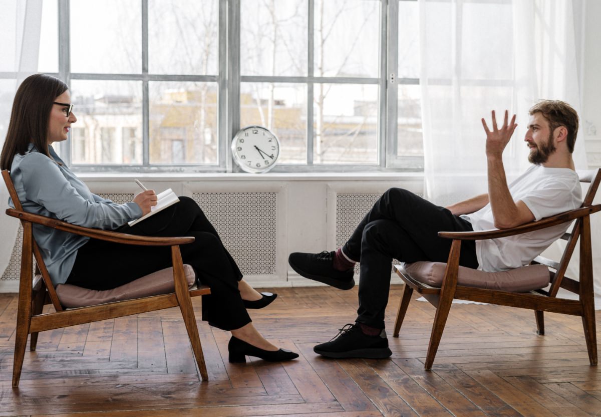 A Female Psychologist listening to a male client