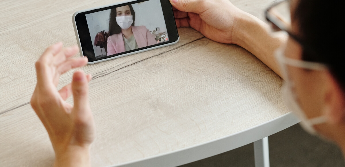 video call on mobile phone wearing mask